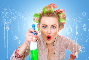 Funny housewife / woman behind window spraying the cleaner on glass, foam / soap on glass